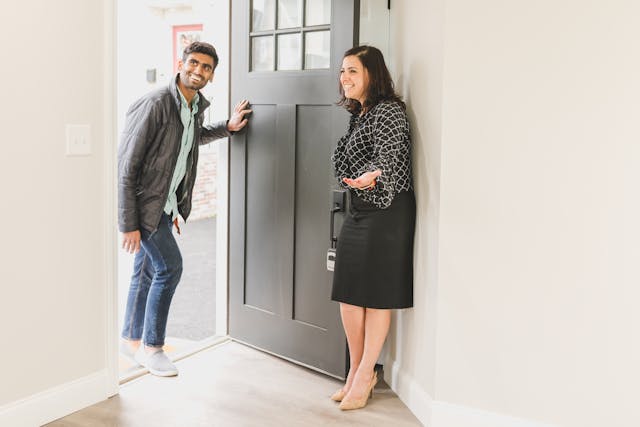 real estate agent welcoming someone in for a property tour